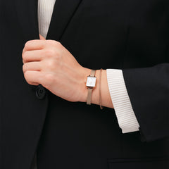 A person wearing the Tide Mesh Bracelet Melrose 1.8 in rose gold, styled alongside a matching watch for a refined, minimalist look with a tailored black blazer.