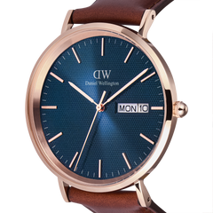 Close-up of the Classic Day Display St Mawes Rose Gold Arctic watch, highlighting the textured blue dial, rose gold case, minimalist hour markers, and the day and date display window.