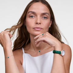 Woman wearing Audrey Ring Malachite Rose Gold, styled with matching green malachite jewellery and rose gold watch.