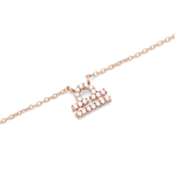 Close-up of a rose gold chain necklace featuring a Libra zodiac pendant adorned with sparkling hand-set crystals.