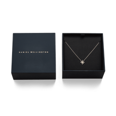 Mirelle Star Necklace Rose Gold displayed in an open Daniel Wellington gift box, highlighting the delicate rose gold chain and sparkling star pendant with cubic zirconia crystals.