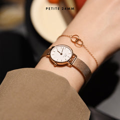 Petite Pressed Melrose 24mm rose gold mesh strap watch with white dial, worn on wrist with a delicate gold bracelet.