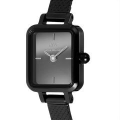 Close-up of the Quadro Mini Reflection Black watch, showcasing its rectangular mirror glass dial, minimalist hour markers, and polished black stainless steel case with a fine mesh strap.