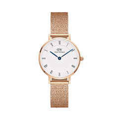Rose gold petite women’s watch with white Roman numeral dial, blue hands, and mesh strap by Daniel Wellington.