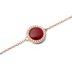 Close-up of Audrey Bracelet featuring a red agate centre stone framed by sparkling cubic zirconia on a rose gold chain.