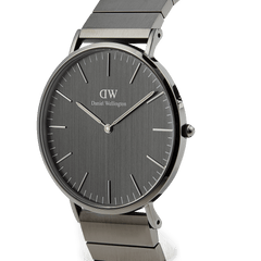 Classic Piano Link Graphite Unitone watch with a brushed graphite dial, minimalist markers, and a geometric graphite stainless steel piano link strap shown in a side profile.