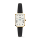 Rectangular gold-plated ladies’ watch with a white dial, bold Roman numerals, blue hands, date display at six o’clock, and a black leather strap. The elegant design combines classic styling with modern touches, ideal for both everyday wear and special occasions.