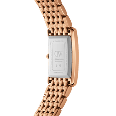 Close-up of the Bound 9-Link Emerald Sunray watch showing the stainless steel case back with engraved branding and the polished rose gold 9-link bracelet.