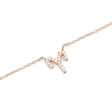 Close-up of a rose gold chain necklace with a sparkling Scorpio zodiac pendant set with hand-placed crystals.