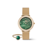 Gold Daniel Wellington watch with a mesh strap, emerald green dial, and crystal-set bezel, paired with a matching gold ring featuring a green stone and delicate crystal accents.