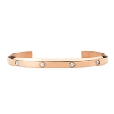 Rose gold open bangle bracelet with a polished finish, featuring eight evenly spaced cubic zirconia crystals set along the band for a refined and minimalist look.