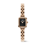 Rectangular rose gold women’s watch with a black sunray dial, minimalist no-index face, and a distinctive arched 3-link bracelet.