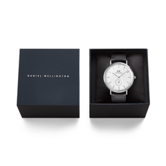 Classic Multi-Eye Sheffield Off-white Sunray Silver watch with a black leather strap, elegantly presented in a navy Daniel Wellington gift box. The minimalist silver case and refined dial make it an ideal gift for special occasions.
