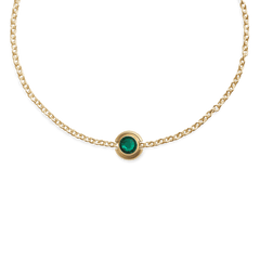 Gold necklace featuring the May Charm Gold with a vivid green crystal centre, set on a delicate gold chain for a refined, modern look.