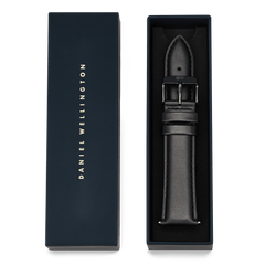 Tapered Sheffield Strap Onyx presented in a navy Daniel Wellington gift box, showcasing the black leather watch strap with onyx black stainless steel buckle and detailed stitching.