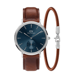 Classic Daniel Wellington watch with a deep blue dial, polished silver case, and brown leather strap, paired with a matching brown leather bracelet featuring a sleek silver clasp.