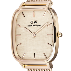 Close-up of the Daniel Wellington Marlon Melrose Linen watch, highlighting the linen-textured dial, minimalist rose gold hour markers, and polished cushion-shaped rose gold case.