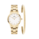 Gold Daniel Wellington watch with a white minimalist dial and matching gold link strap, paired with an engraved gold cuff bracelet, both crafted in polished stainless steel for a refined, timeless look.