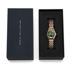 Ophelia Mini Emerald Rose Gold watch with an emerald green dial and rose gold beans link bracelet, elegantly presented in a black Daniel Wellington gift box.