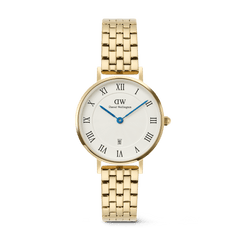 Gold Daniel Wellington women’s watch with a five-link bracelet, white guilloché dial, bold Roman numerals, blue hands, and a date window at 6 o’clock.