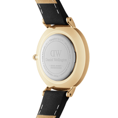 Back view of Petite Roman Numerals Sheffield Gold watch showing engraved caseback and black leather strap detailing.