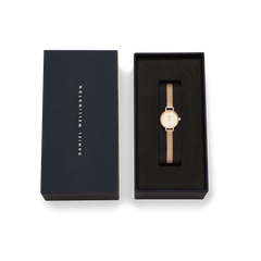 Petite Mini Champagne Melrose watch with a rose gold mesh strap presented in an elegant navy Daniel Wellington gift box.