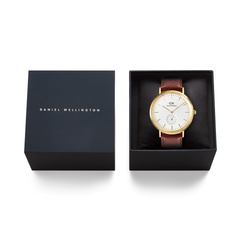Classic Multi-Eye St Mawes Off-white Sunray Gold watch with a brown leather strap presented in an elegant black Daniel Wellington gift box, ideal for special occasions.