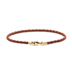 Slim braided brown leather bracelet featuring a polished gold-tone stainless steel lobster clasp, engraved with subtle branding for an elegant and versatile look.