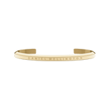 Minimalist gold open cuff bracelet by Daniel Wellington with a slim profile and subtle engraved branding.