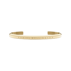 Minimalist gold open cuff bracelet by Daniel Wellington with a slim profile and subtle engraved branding.