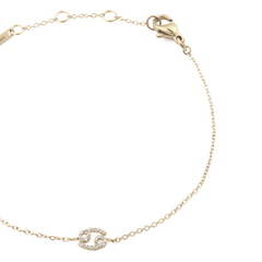 Gold chain bracelet with an adjustable fit, featuring a crystal-studded zodiac pendant and a secure lobster clasp.