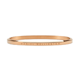 Slim rose gold bangle crafted from polished stainless steel, featuring a minimalist design with subtle Daniel Wellington engraving along the outer edge.