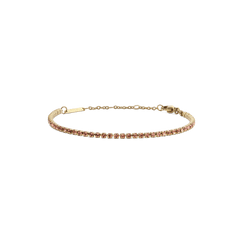 Delicate gold tennis bracelet featuring a single row of apricot-coloured Preciosa crystals, finished with an adjustable chain and secure lobster clasp.