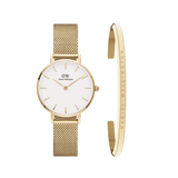 Petite gold mesh strap watch with a minimalist white dial, paired with a slim gold cuff bracelet engraved with subtle Daniel Wellington branding, both crafted in polished gold-tone steel.