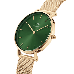 Petite Emerald Gold women’s watch with emerald green dial and gold mesh strap, minimalist round case by Daniel Wellington.