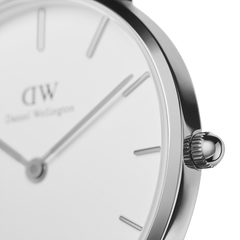 Close-up of Petite Sterling women’s watch showing polished silver case, minimalist white dial, and sleek hour markers.