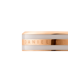Close-up of the Emalie Ring Desert Sand Rose Gold, showing the engraved Daniel Wellington signature on a polished rose gold band with a smooth desert sand enamel inlay.