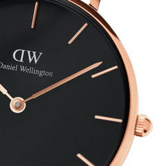 Detail view of the Petite Sheffield watch highlighting the sleek black dial, rose gold hands and markers, and the refined rose gold case.