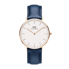 Elegant Classic Somerset watch with a slim rose gold case, minimalist white dial, and navy blue leather strap.