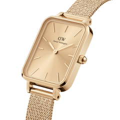 Quadro Pressed Unitone Gold watch with rectangular gold dial and pressed mesh strap, featuring a polished minimalist design.