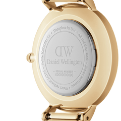 Engraved case back of Petite Sheffield Gold women’s watch, featuring gold stainless steel and Daniel Wellington branding.