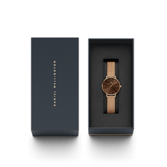 Petite Amber rose gold women’s watch with an amber brown dial and mesh strap, elegantly presented in a Daniel Wellington signature gift box.