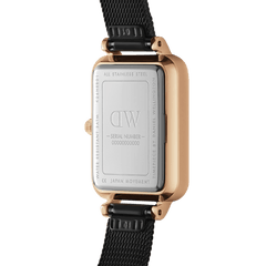 The reverse side of the Quadro Pressed Ashfield watch showing the engraved stainless steel case back, rose gold detailing, and black mesh strap.