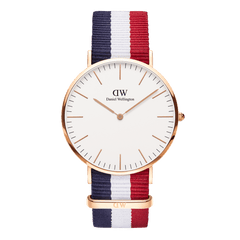 Daniel Wellington Classic Cambridge Rose Gold watch with a slim rose gold case, minimalist white dial, and a blue, white, and red striped NATO strap.