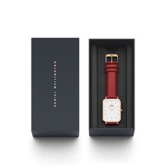 Quadro Pressed Suffolk rose gold women’s watch with a rectangular white dial and cherry blush red leather strap, elegantly presented in a Daniel Wellington gift box.