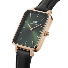 Rectangular Daniel Wellington women’s watch featuring an emerald green dial, rose gold-plated case, minimalist hour markers, and a black leather strap.