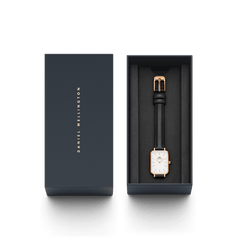 Daniel Wellington Quadro Pressed Sheffield watch with a rectangular eggshell white dial, rose gold case, and black leather strap, elegantly presented in a branded gift box.