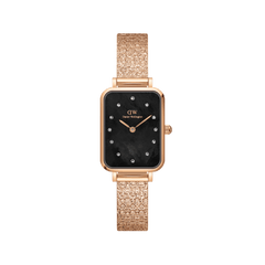 Rectangular rose gold women’s watch with a pressed piano link strap, black mother of pearl dial, and crystal-set indexes.