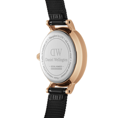 Close-up of the Petite Pressed Ashfield watch showing the engraved stainless steel case back, rose gold casing, and black pressed mesh strap.
