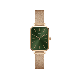 Rose gold Daniel Wellington women’s watch with emerald green square dial and pressed mesh strap, minimalist and elegant design.